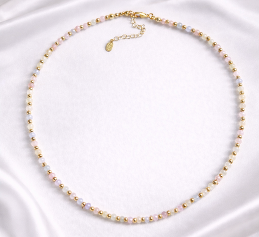 Necklace with light tone agate beads on a white satin background