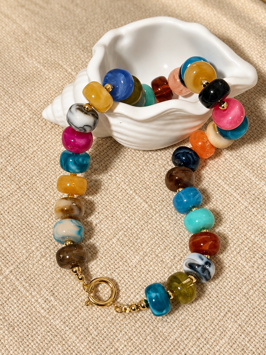 The Riviera Beaded Necklace featuring colorful premium acrylic  beads and a front toggle clasp handmade by ximena Lopez golden touch accessories 