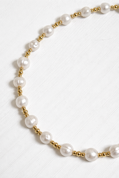 Minimal pearl necklace flat lay gold beads