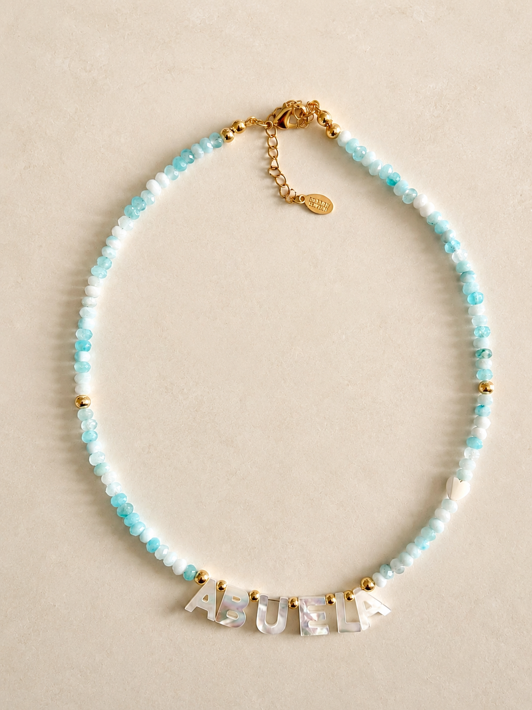 Turquoise agate beads Necklace with 'ABUELA' LETTERS on a beige background