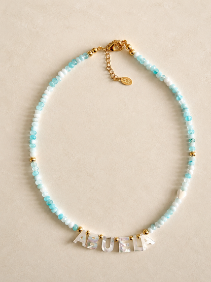 Turquoise agate beads Necklace with 'ABUELA' LETTERS on a beige background