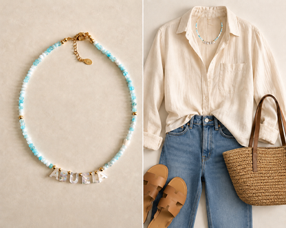 Necklace with 'ABUELA' on a beige background, paired with a cream shirt, jeans, sandals, and a straw bag.