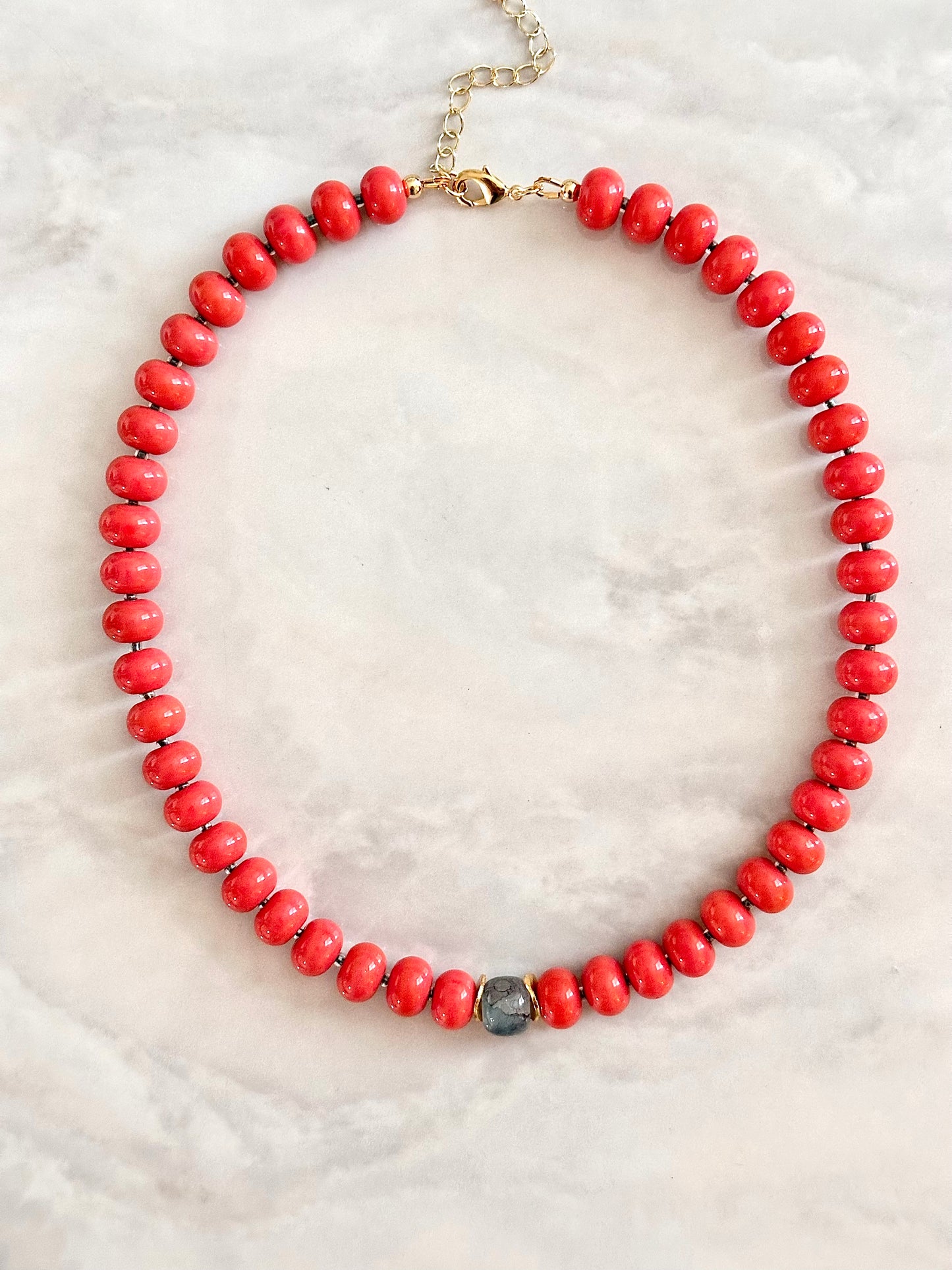 Necklace with coral beads and a single marble gemstone centerpiece 