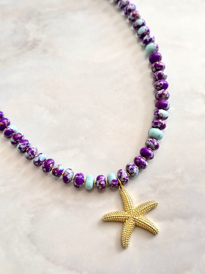 Beaded necklace with a starfish pendant on a light background