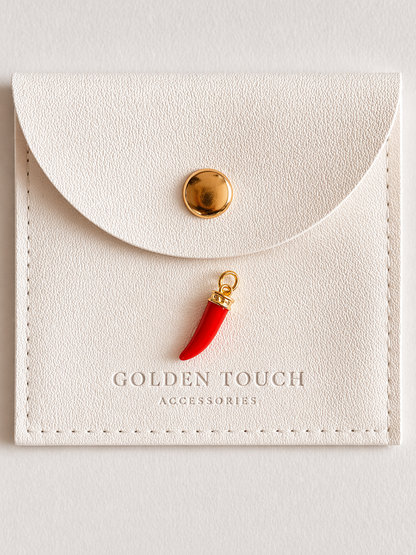 Red horn-shaped charm with gold accent on a white card with 'Golden Touch Accessories' branding.