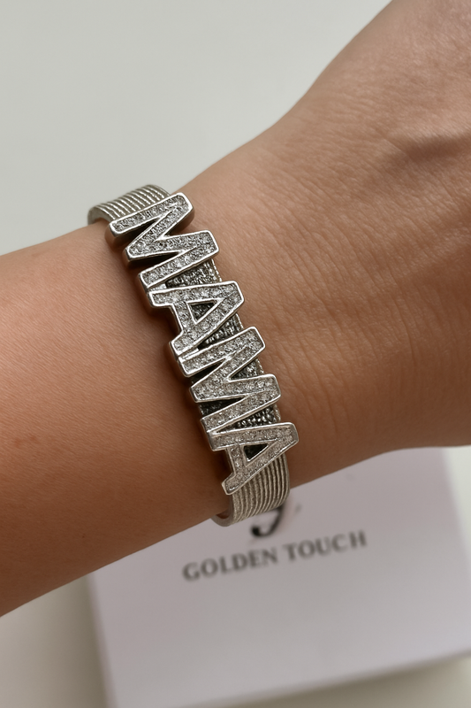 Silver bracelet with 'AMANA' on a wrist, brand 'Golden Touch' visible